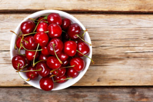 Cherry on a wooden background. View from above